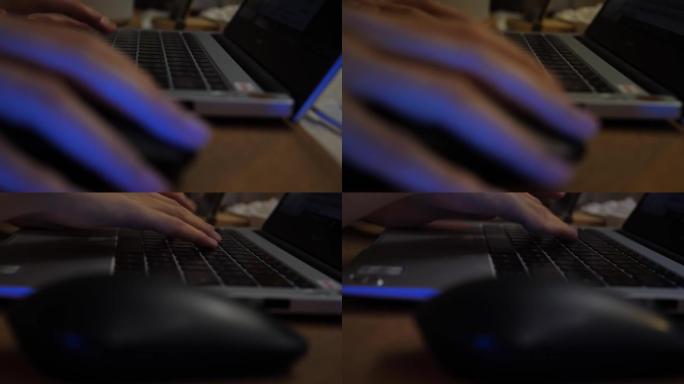 特写，一个女人的手在晚上用笔记本电脑放在桌子上。