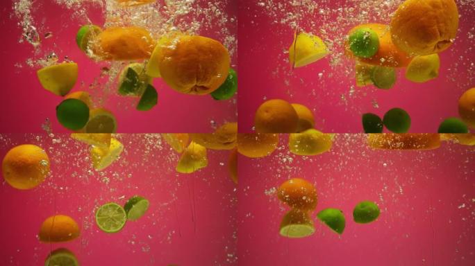 混合外来柑橘类水果在慢动作中落入水中-葡萄柚，柠檬，橙子，酸橙