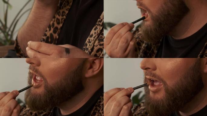 一名男性化妆师在嘴唇上涂抹口红的4k视频片段