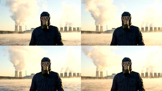 核电站冷却塔的延时发电厂将化学物质释放到大气中。一个人戴着防毒面具站着。储液罐蒸发了。全球变暖和辐射