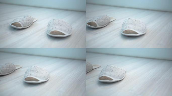 家用白色拖鞋特写镜头形状不好，破旧，移动相机