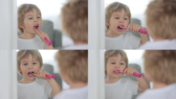 可爱的蹒跚学步的孩子，金发男孩，在家刷牙，与世隔绝