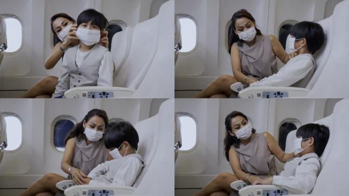 亚洲母亲在航空公司为儿子戴口罩。坐飞机旅行时。COVID19疫情期间的旅行安全措施。概念保健