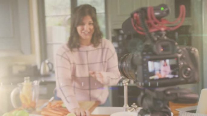 摄像机上的发光动画，女性视频记录器在家记录烹饪视频日志