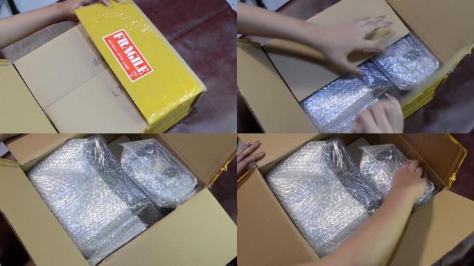 一位修剪整齐的少女用切刀打开一个纸板箱。