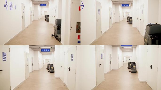 在购物中心或办公楼的长廊中行走的4k视频。通向男女厕所和门卫室的门