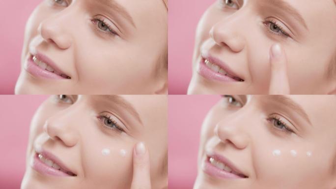 女性护肤模特将眼霜涂在脸上微笑的镜头