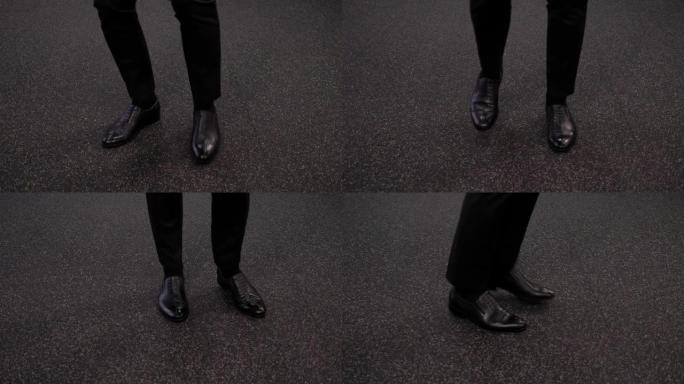 办公室地板上一个商人穿着鞋子的脚的特写镜头，欢欣鼓舞地跳舞。
