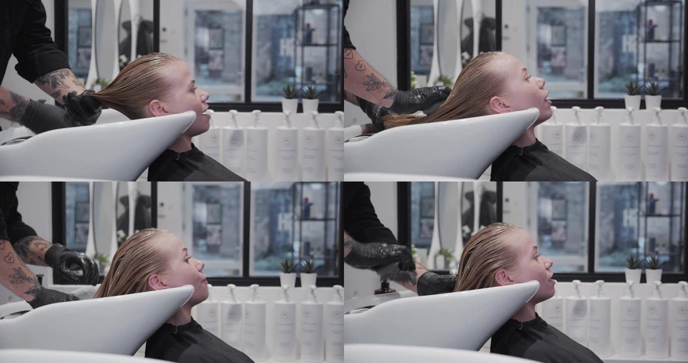 理发师将头发产品刷入女性的湿头发