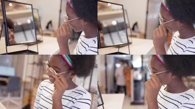 少女顾客在商店里选择新眼镜。