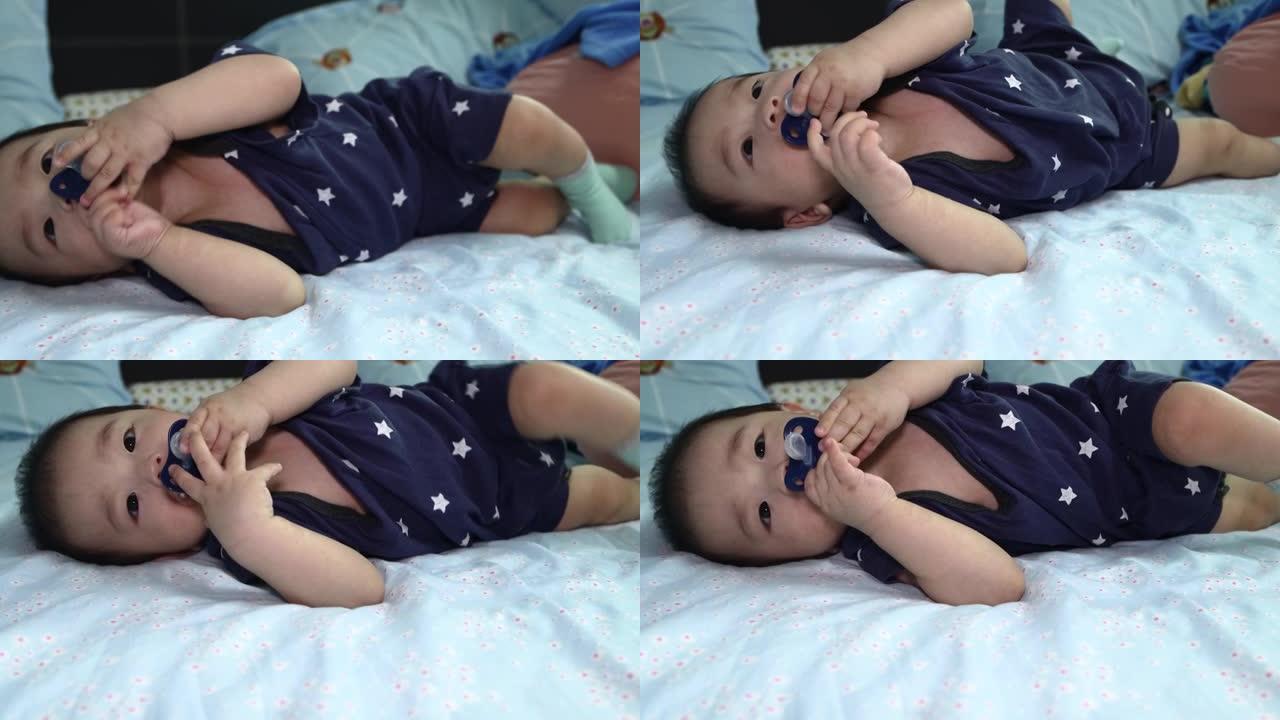 8个月中国男婴吸吮奶嘴准备入睡的当地生活方式