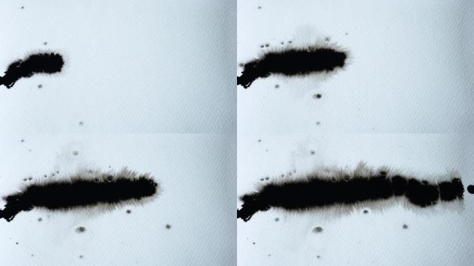 黑色墨滴落在湿纸上的白纸上，膨胀。从左到右传播墨水。抽象水墨艺术。慢动作。特写