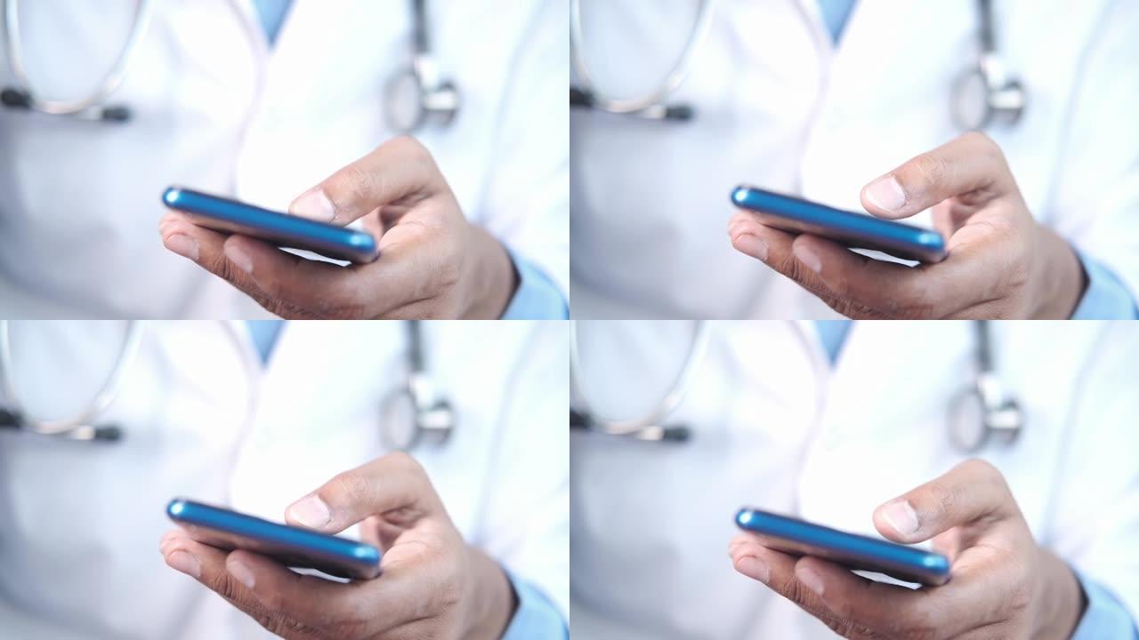 用智能手机穿白大褂的医生。