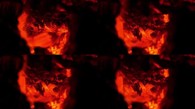 农村烤箱里闷烧柴火。木炉的红色燃烧火焰。舒适的热壁炉篝火燃烧在晚上。明亮温暖的屏幕保护4K，用于餐厅