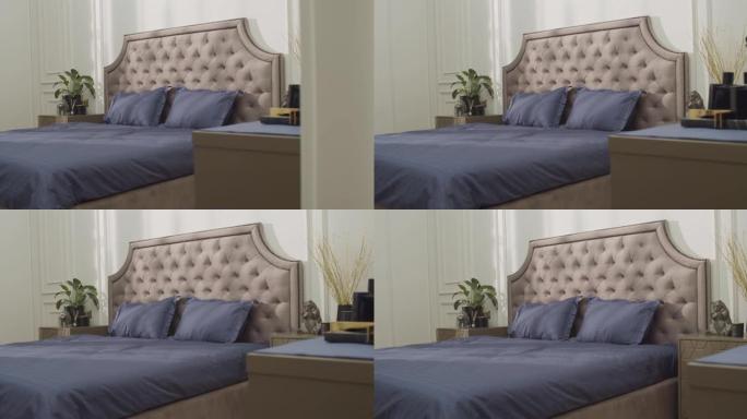 相机放大大灰色软垫双人床，上面配有紫色亚麻布
