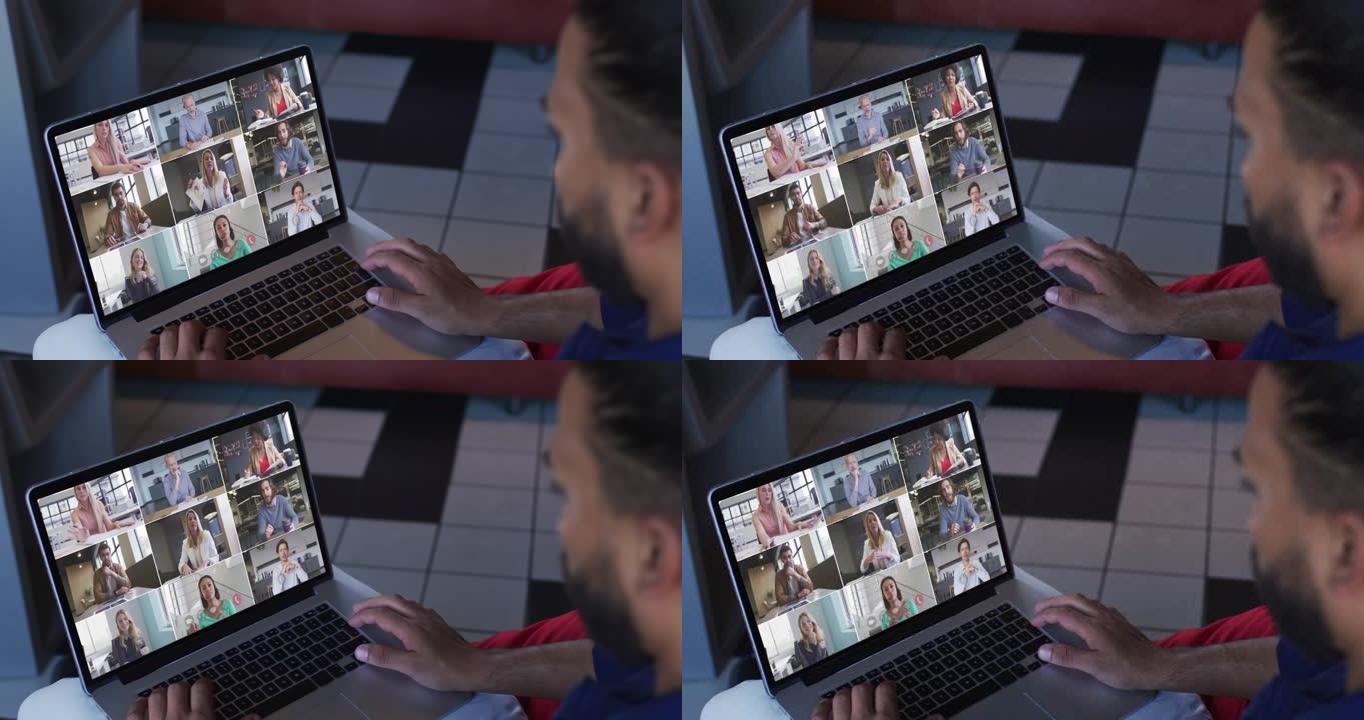 中东男子在笔记本电脑上与办公室同事进行视频会议