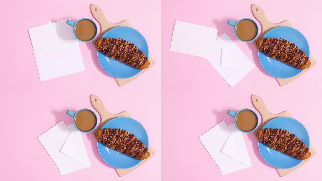 纸卡纸条出现在巧克力羊角面包和一杯咖啡旁边的信封上。停止运动
