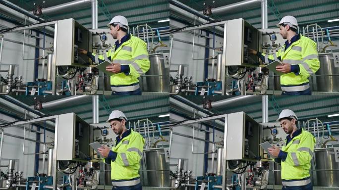 技术工程师用笔记本电脑检查变压器电源控制面板的状况，以观察饮料生产厂的异常运行状态