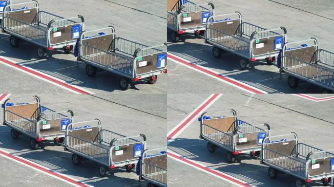 在机场的客机上运送和装载行李和行李的空手推车或手推车的4k视频