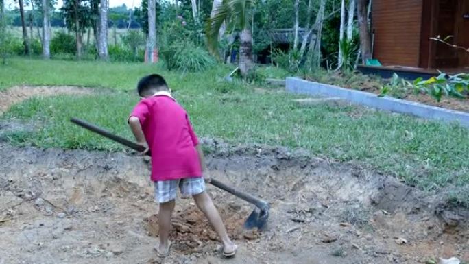 用铲子挖土的孩子