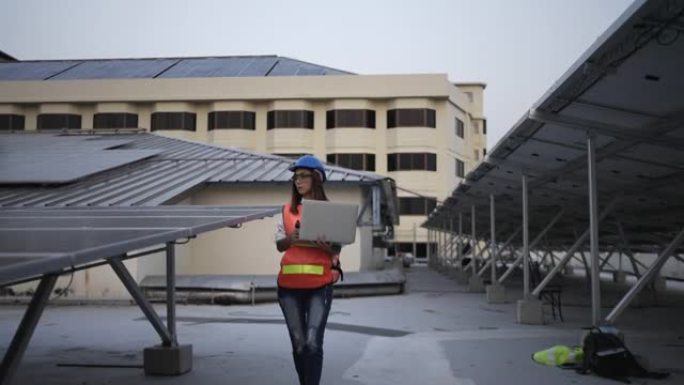 女工程师检查安装太阳能电池板。