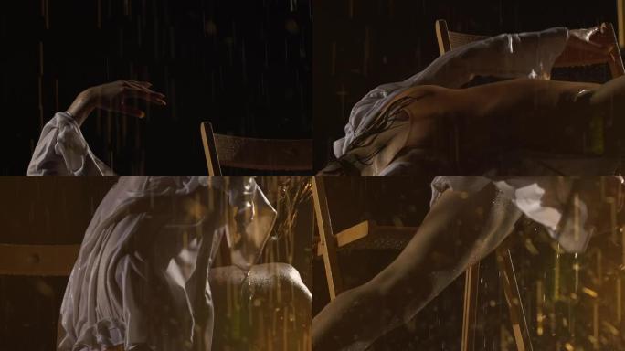 年轻芭蕾舞演员表演的当代芭蕾舞的感性编舞。在黑暗的工作室里，温柔潮湿的女人坐在椅子上，在倾盆大雨中平