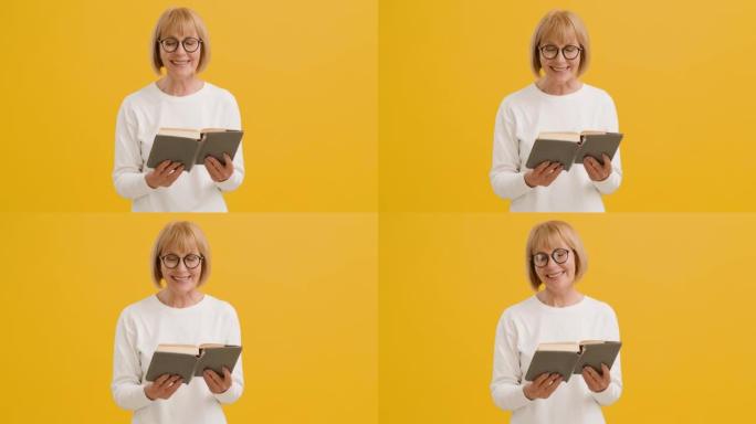 自我教育。戴着眼镜的快乐高级女士看书和大笑，享受喜欢的文学作品，橙色背景