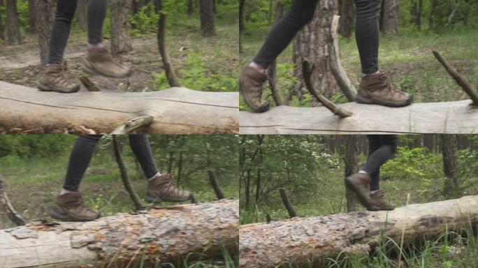 穿着远足靴的徒步旅行者女孩在森林里的树干旁行走的特写镜头