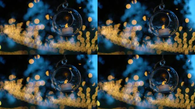 美丽浪漫的婚礼派对在花园背景圆形玻璃蜡烛球悬挂装饰