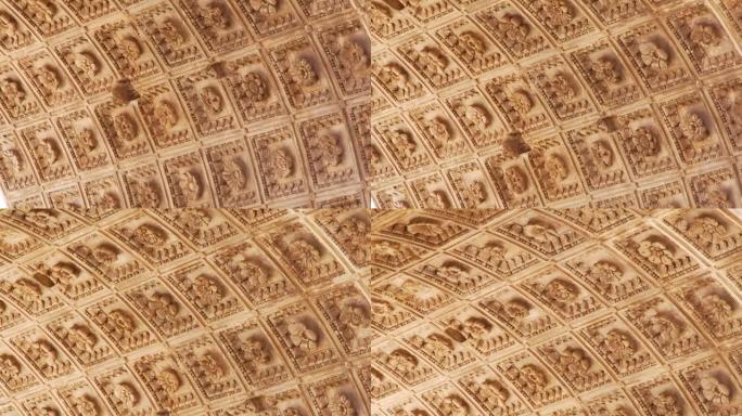 罗马雕刻花卉图案的大理石天花板特写。摄像机沿着装饰立面移动