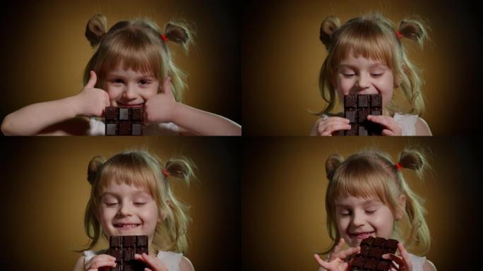 小孩女孩孩子吃巧克力棒甜点，在黑暗的背景上显示出孤立的大拇指