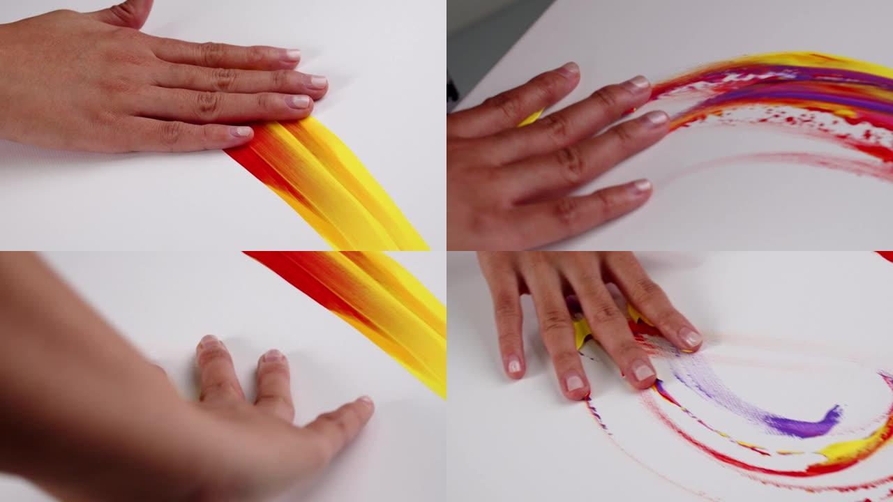 女艺术家用手作为画笔在白色画布上涂上颜色