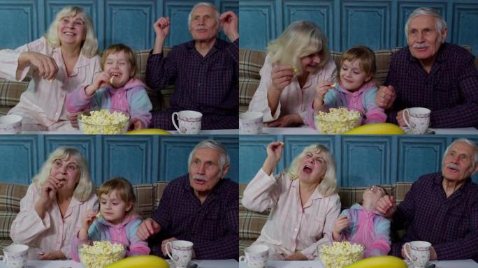 爷爷奶奶在家和孙女一起在电视电视上看动画片电影开心笑