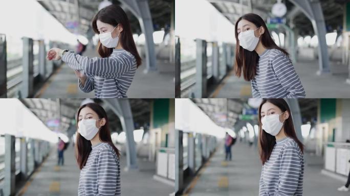 戴着口罩的亚洲妇女在月台上行走，等待电动火车。