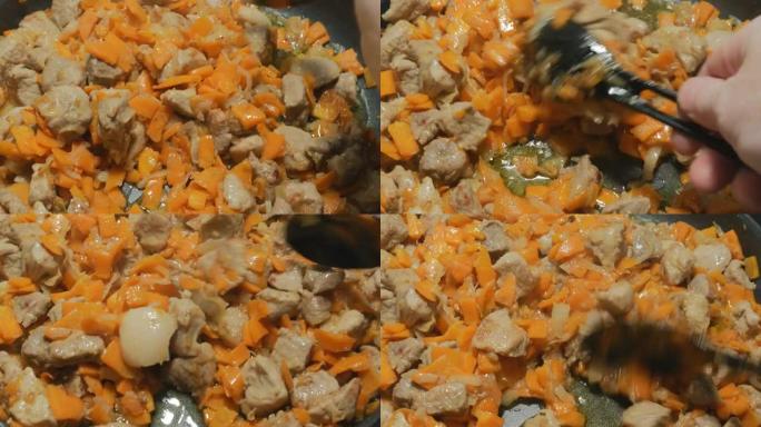 厨师在大锅中煎炸时，将烤猪肉与蔬菜混合。很大。现场摄像机。看起来很好吃。洋葱、胡萝卜和香料炒肉。4K