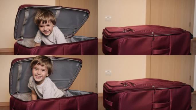 小孩在手提箱里玩。旅行车里的小孩。打包度假。快乐的儿童男孩游客从红色手提箱中寻找旅行度假冒险。孩子在