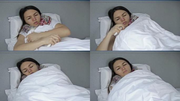 生病的年轻女子用毯子包裹自己。她有流感、感冒或冠状病毒的症状