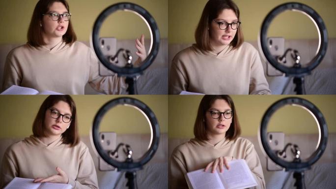 带眼镜的女孩书博客作者在数字智能手机摄像头上录制vlog