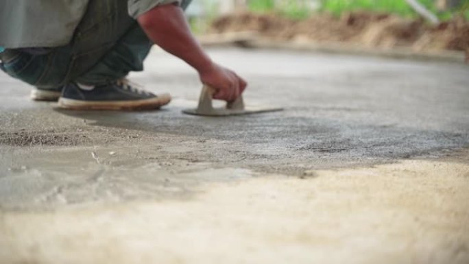 亚洲工人在混凝土水泥地板上工作