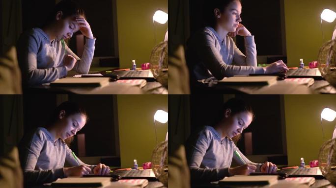 女孩在家庭学习时使用笔记本电脑