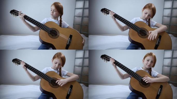 红发博主女孩在相机上弹吉他。一个自学成才的女孩喜欢在她的视频博客上让订阅者感兴趣
