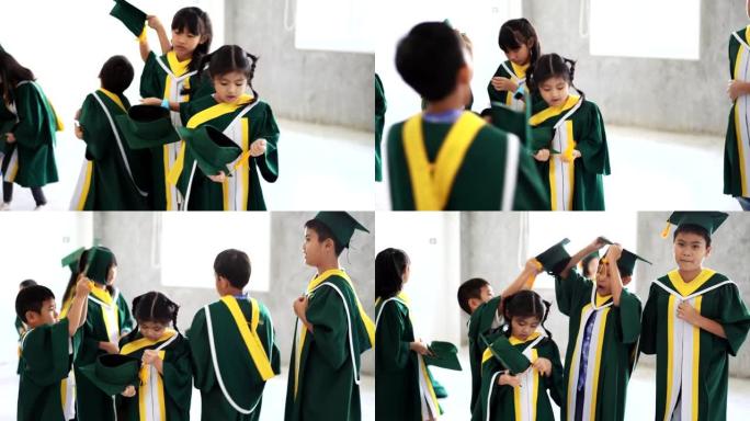 童年学生和朋友穿着毕业礼服