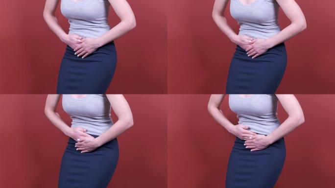 女人握着胃。月经疼痛或肠道问题。