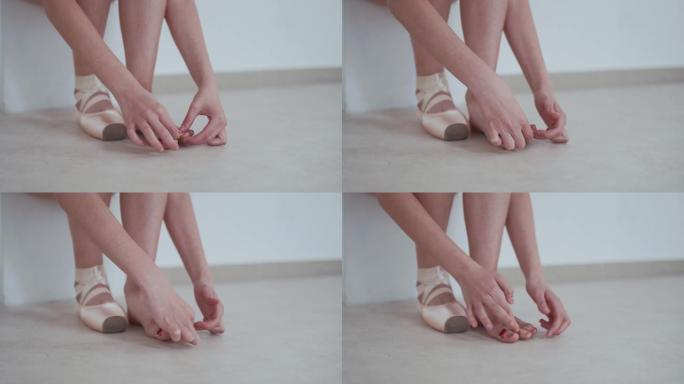 芭蕾舞女演员在受伤的脚上戴上创可贴