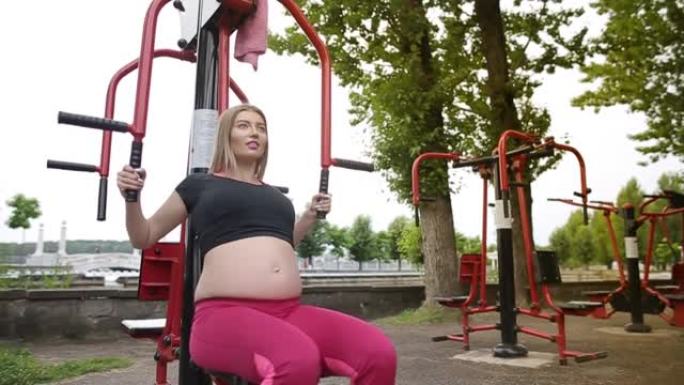 一个肚子很大的怀孕女孩在户外锻炼