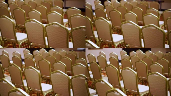 一排白色座椅的背景。会议厅里的空毛