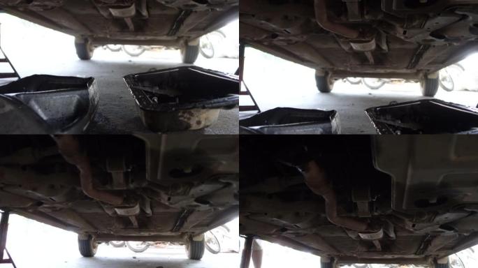 汽车下方的机油滴落在机械车库的角度检查