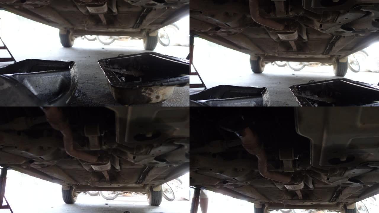 汽车下方的机油滴落在机械车库的角度检查