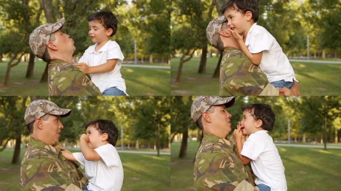 强壮的军人父亲抱着小儿子