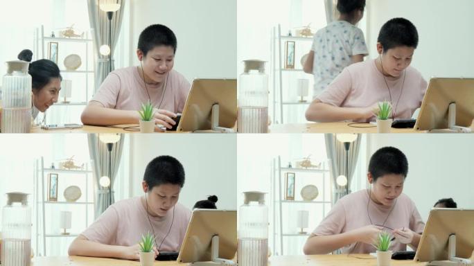 在新型冠状病毒肺炎，检疫和社交距离的生活方式概念中，亚洲女孩在家里的餐桌上通过数字平板电脑学习在线课